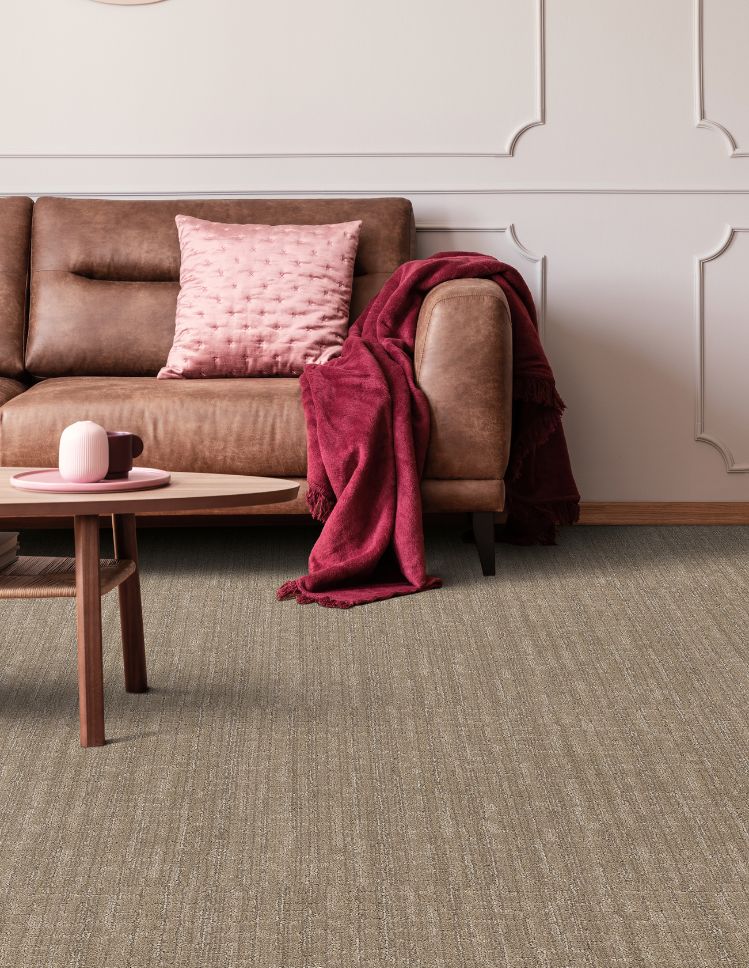 brown textured carpets in a n Irvine living room with brown leather couch and pink accents