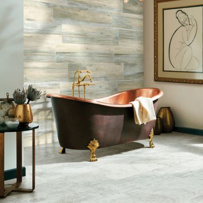 tile flooring installation in a bright Irving, CA, bathroom with freestanding copper tub and wood look tile wall accent